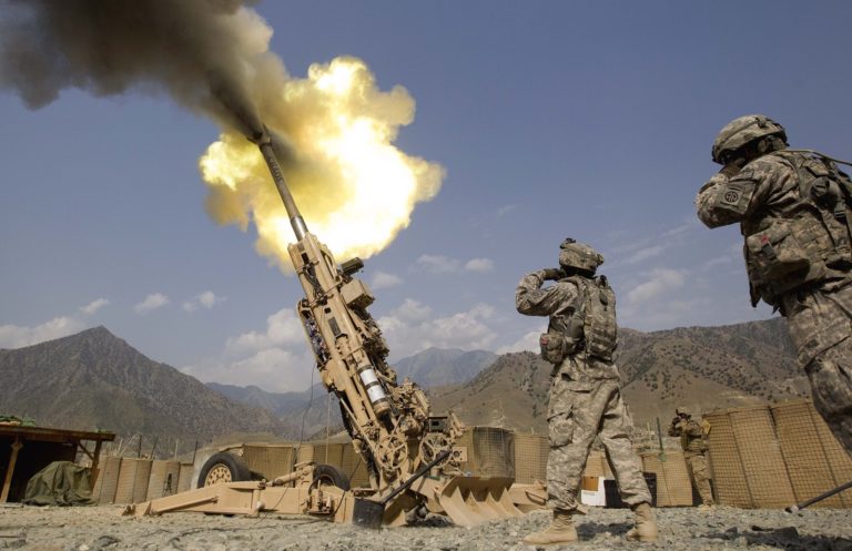 FILE - A 155mm round is fired from a 777 Howitzer canon at insurgents during a firing mission by soldiers with 2nd Platoon, Charlie Battery, 3rd Battalion, 321 Field Artillery Regiment out of Fort Bragg, N.C., July 8, 2011, at Forward Operating Base Bostick in Kunar province, Afghanistan. The Biden administration's decision to dramatically ramp up delivery of artillery guns to Ukraine eight weeks into the war signals a deepening American military commitment at a pivotal stage of fighting for the country's industrial heartland. Russia Ukraine War Military Aid Explainer