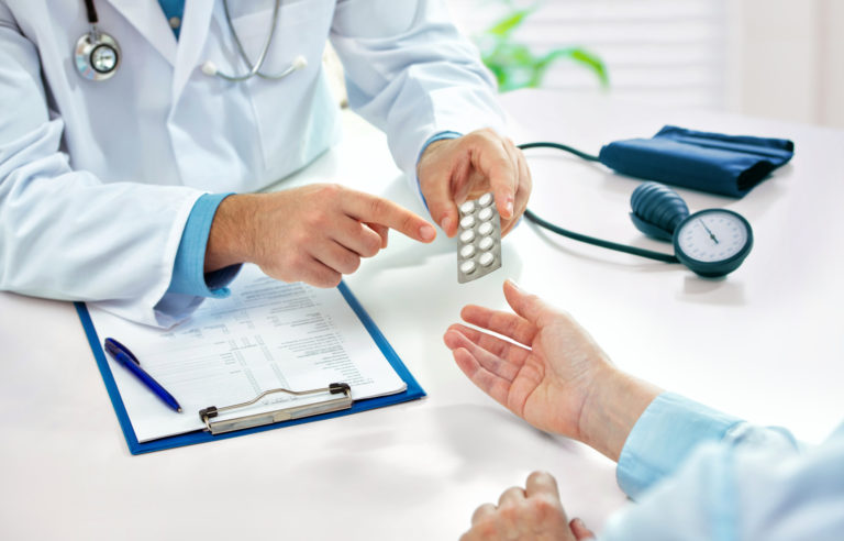 Doctor prescribing medicine to a patient in the office
