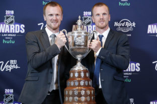 FILE - Daniel Sedin, right, and Henrik Sedin pose with the King Clancy Memorial Trophy after winning the award at the NHL Awards, Wednesday, June 20, 2018, in Las Vegas. Swedes Henrik and Daniel Sedin and Daniel Alfredsson have been elected to the Hockey Hall of Fame. Goaltender Roberto Luongo, Finnish women’s star Riikka Sallinen and builder Herb Carnegie were also selected Monday, June 27, 2022, to be inducted in November. ()
