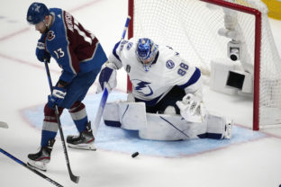 Colorado Avalanche right wing Valeri Nichushkin, left, redirects the puck at Tampa Bay Lightning goaltender Andrei Vasilevskiy during the third period of Game 5 of the NHL hockey Stanley Cup Final