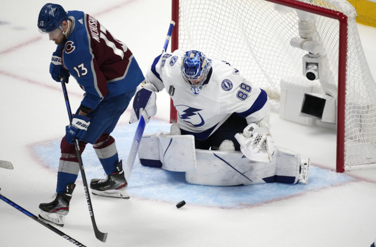 Colorado Avalanche right wing Valeri Nichushkin, left, redirects the puck at Tampa Bay Lightning goaltender Andrei Vasilevskiy during the third period of Game 5 of the NHL hockey Stanley Cup Final