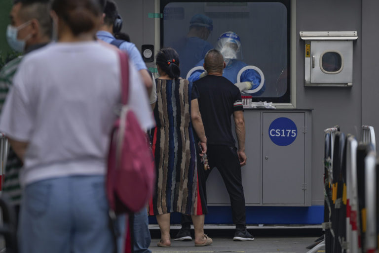 Residents line up for a throat swab at a coronavirus testing facility outside a neighborhood in Beijing