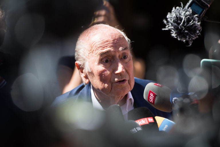 The former Fifa President, Joseph Blatter, center, surrounded by media representatives, waves to the press in front of the Swiss Federal Criminal Court in Bellinzona, Switzerland, at the last day of the trail, after the verdict has been announced, Friday, July 8, 2022. The trial ended with an acquittal. Blatter and Michel Platini, former president of the the European Football Association (Uefa), stood trial before the Federal Criminal Court over a suspicious two-million payment. The Federal Prosecutor's Office accused them of fraud. The defense spoke of a conspiracy. ()
