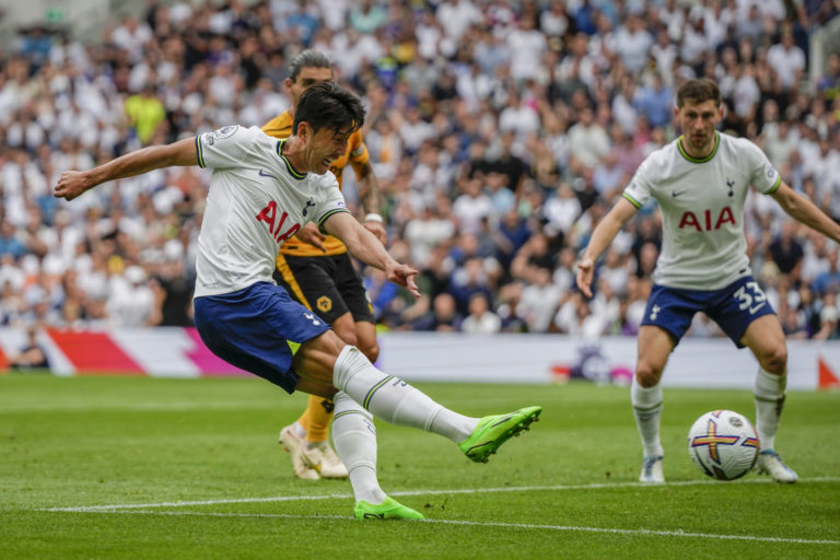 Tottenham's Son Heung-min, left, kicks the ball during the English Premier League soccer match between Tottenham Hotspur and Wolverhampton Wanderers at Tottenham Hotspur in London, Saturday