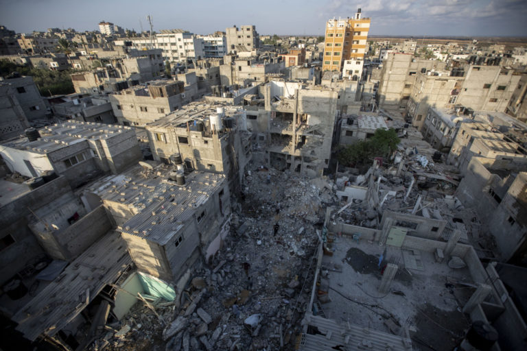 Palestinians search through the rubble of a building in which Khaled Mansour, a top Islamic Jihad militant was killed following an Israeli airstrike in Rafah, southern Gaza strip, Sunday, Aug. 7, 2022. An Israeli airstrike killed a senior commander in the Palestinian militant group Islamic Jihad, authorities said Sunday, its second leader to be slain amid an escalating cross-border conflict