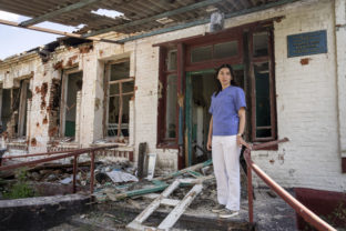 Dr. Ilona Butova stands in front of the therapy department which was destroyed after a Russia attack on the hospital in Zolochiv, Kharkiv region, Ukraine, Sunday, July 31, 2022. Ukraine's health care system already was struggling due to corruption, mismanagement and the COVID-19 pandemic. But the war with Russia has only made things worse, with facilities damaged or destroyed, medical staff relocating to safer places and many drugs unavailable or in short supply