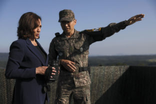 U.S. Vice President Kamala Harris, left, holds binoculars at the military observation post as she visits the demilitarized zone (DMZ) separating the two Koreas, in Panmunjom, South Korea