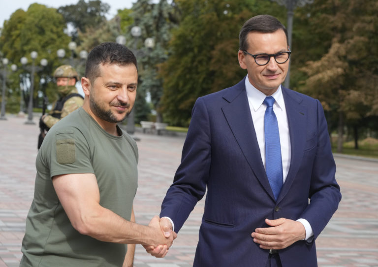 Ukrainian President Volodymyr Zelenskyy, left, and Poland's Prime Minister Mateusz Morawiecki shake hands during their meeting in Kyiv, Ukraine