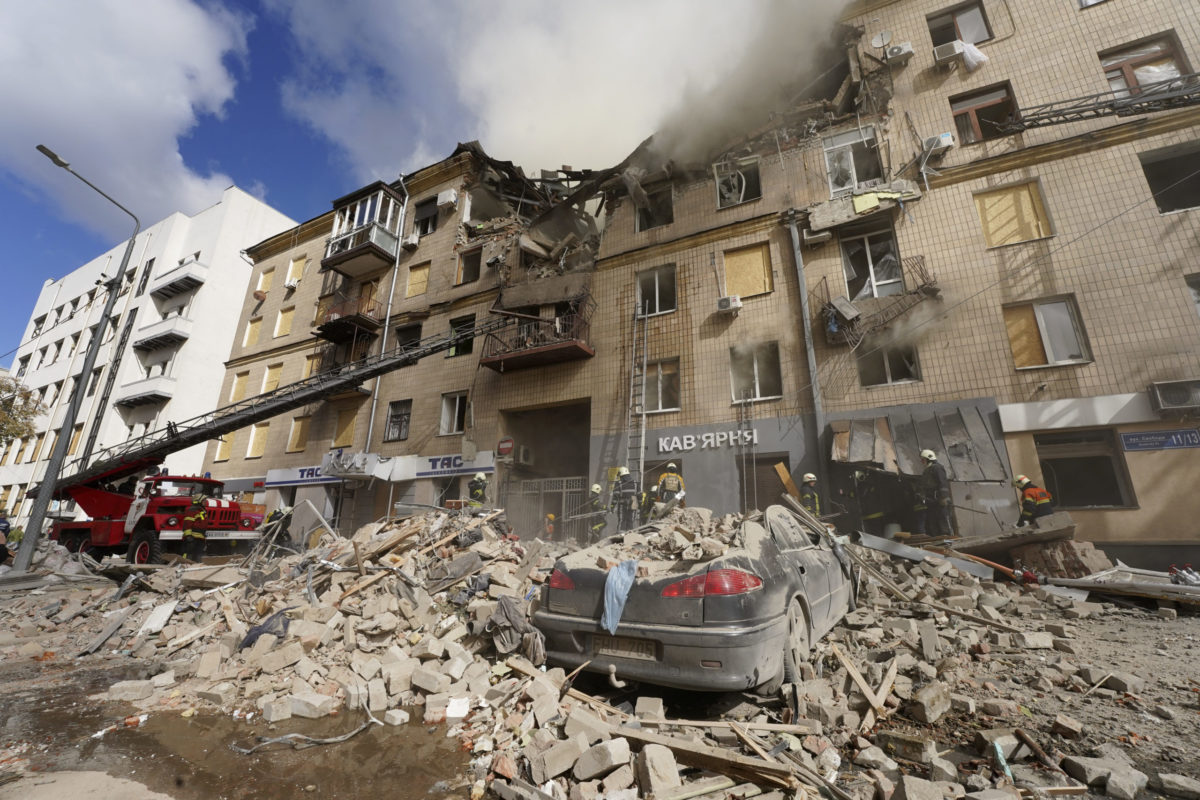 Ukrainian firefighters work on heavily damaged buildings after latest Russian rocket attack in center Kharkiv, Ukraine