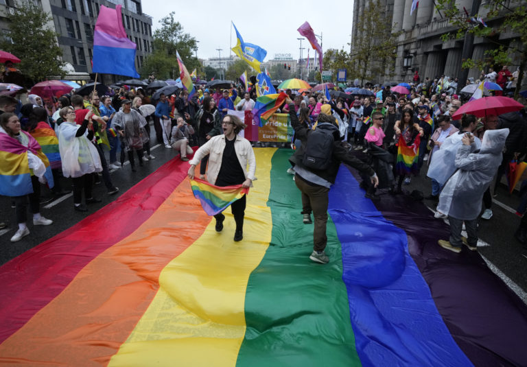 People take part in the European LGBTQ pride march in Belgrade, Serbia, Saturday, Sept. 17, 2022. Serbian police have banned Saturday's parade, citing a risk of clashes with far-right activists