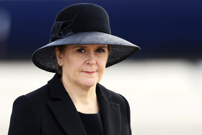 Scotland's First Minister Nicola Sturgeon is seen as Britain's King Charles III and Camilla, the Queen Consort, arrive at Edinburgh Airport, Monday, Sept. 12, 2022. King Charles arrived in Edinburgh on Monday to accompany his late mother’s coffin on an emotion-charged procession through the historic heart of the Scottish capital to a cathedral where it will lie for 24 hours to allow the public to pay their last respects