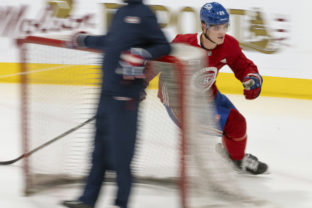 Juraj Slafkovsky makes a turn around the net at the Montreal Canadiens NHL hockey training camp in Brossard, Quebec