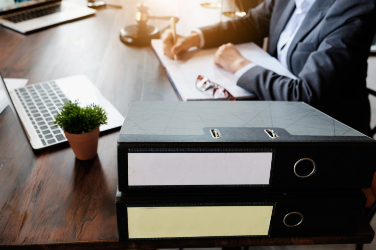 Close up lawyer businessman working or reading lawbook in office workplace for consultant lawyer concept.