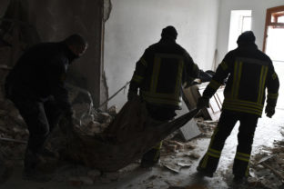 Rescuers remove the remains of a man, from the debris at Holy Mountains Lavra of the Holy Dormition in the liberated town of Sviatohirsk, Donetsk region, Ukraine