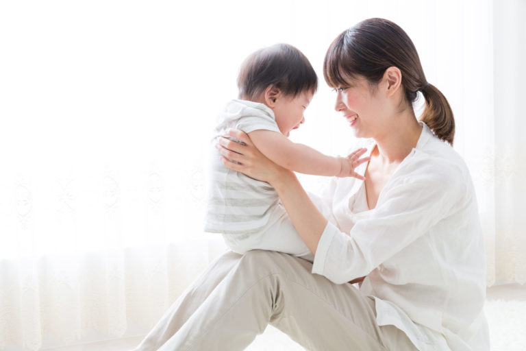 Asian mother and baby in living room