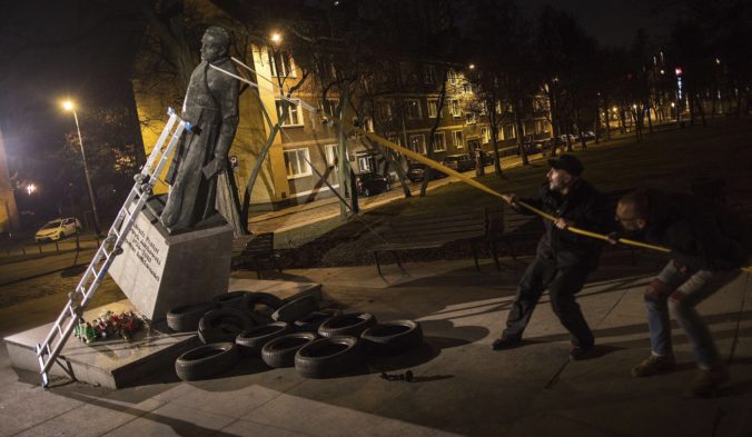 FILE - Activists in Poland pull down a statue of a prominent deceased priest, Father Henryk Jankowski, who allegedly abused minors sexually, in Gdansk, Poland, Feb. 21, 2019. The Gdansk district court on Monday, Nov. 7, 2022, acquitted three men who in 2019 toppled a statue of a late priest suspected of sexually abusing minors, a symbolically dramatic moment in the traditionally Catholic country's reckoning with clerical abuse