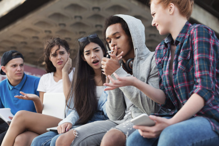 Black,Teen,Guy,Smoking,Cigarette,,His,Friends,Judging,Him.,Social