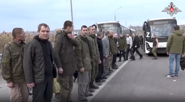 In this handout photo taken from video released by Russian Defense Ministry Press Service on Friday, Nov. 4, 2022, a group of Russian soldiers stand after being released in a prisoners swap in the Donetsk People's Republic, eastern Ukraine. The Russian Defense Ministry released video late Thursday, saying it showed Russian soldiers released as part of a prisoners swap. The ministry said in a statement that "107 Russian military personnel who were in captivity were returned" from the Kyiv-controlled territory.