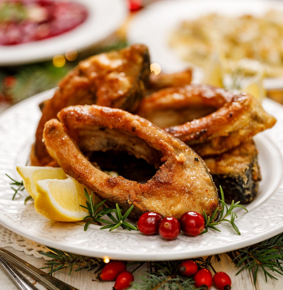Christmas carp, Fried carp fish slices on a white plate, close u