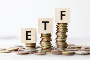 ETF Exchange Traded Fund wording on wooden cubes with coins
