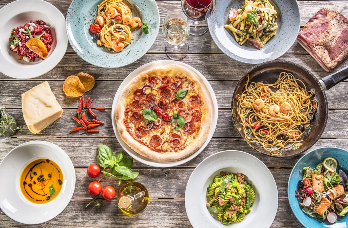 Top,Of,View,Full,Table,Of,Italian,Meals,On,Plates