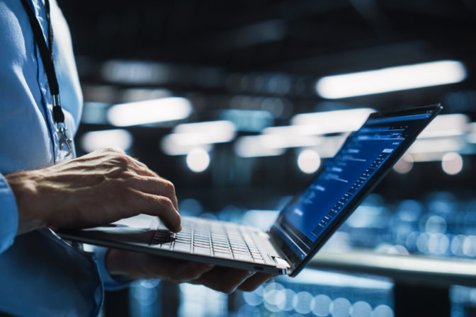 Data Center Programmer Using Digital Laptop Computer, Maintenance IT Specialist. Cloud Computing Server Farm System Administrator Working on Cyber Security for Iaas, saas, paas. Closeup Focus on Hands