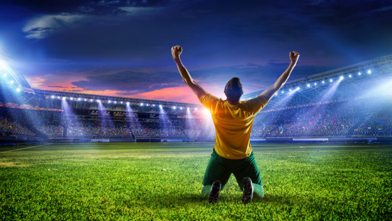 Soccer player at stadium. Mixed media