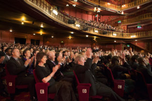 Audience applauding in theater