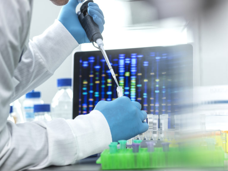Scientist pipetting sample into a vial for DNA testing