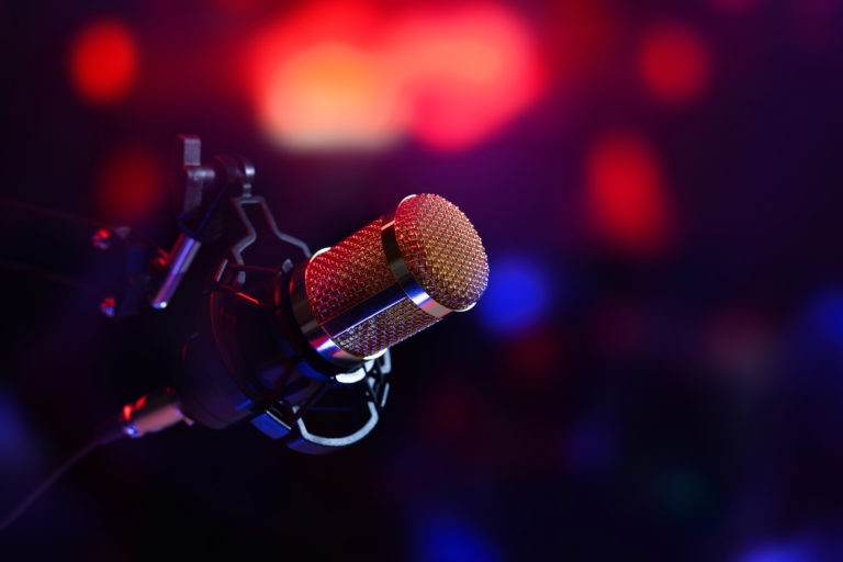Studio microphone in neon lights. sound recording equipment