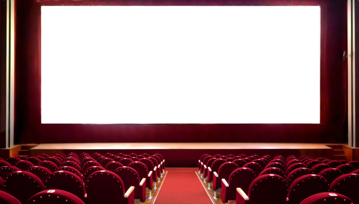 Empty red cinema seats with blank white screen for adding a picture