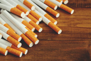 Image of several commercially made cigarettes. pile cigarette on wooden. or Non smoking campaign concept, tobacco