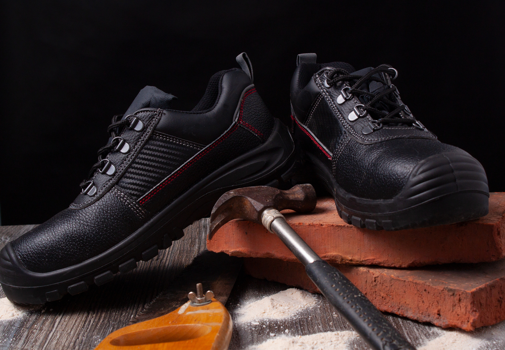 Still,Life,Of,Two,Safety,Shoes,With,A,Hammer,And
