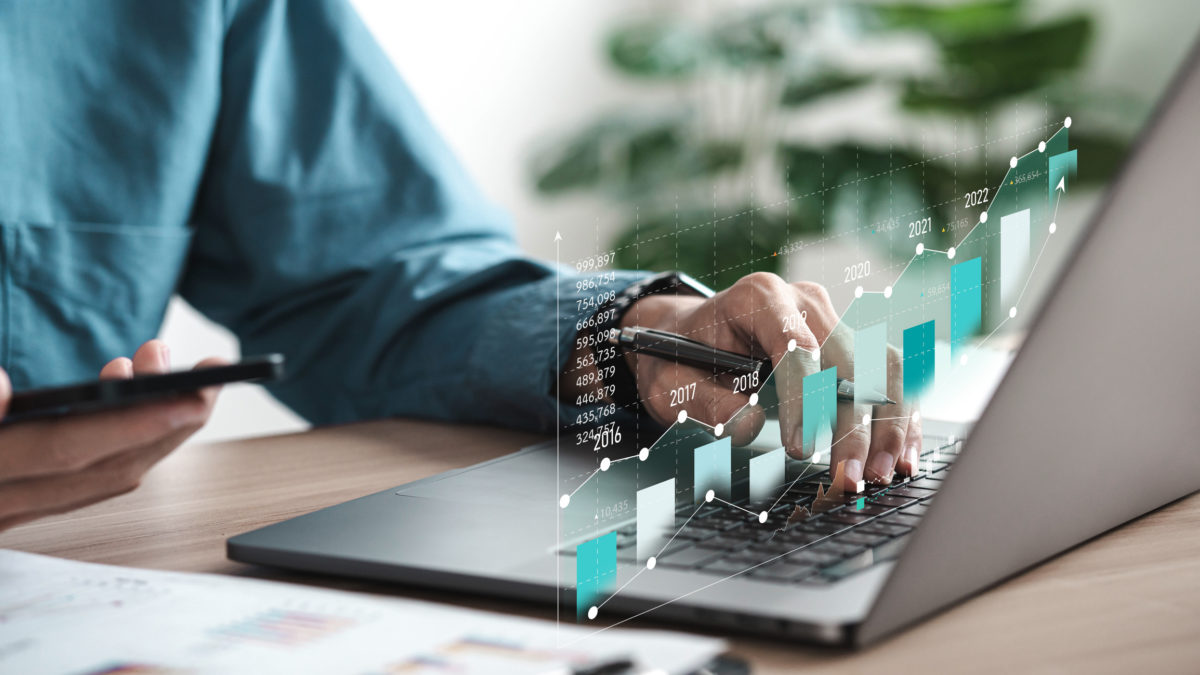 Businessman analyzing digital financial balance sheet of company working with digital virtual graphic design. Calculating long term investment financial data icon on touch screen
