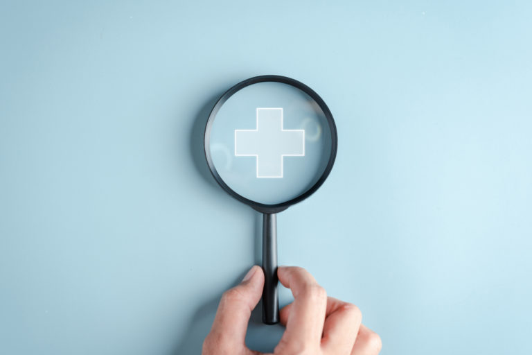 Health insurance concept. Hand people holding Magnifier focus to plus symbol and healthcare medical icon, health and access to welfare health concept.