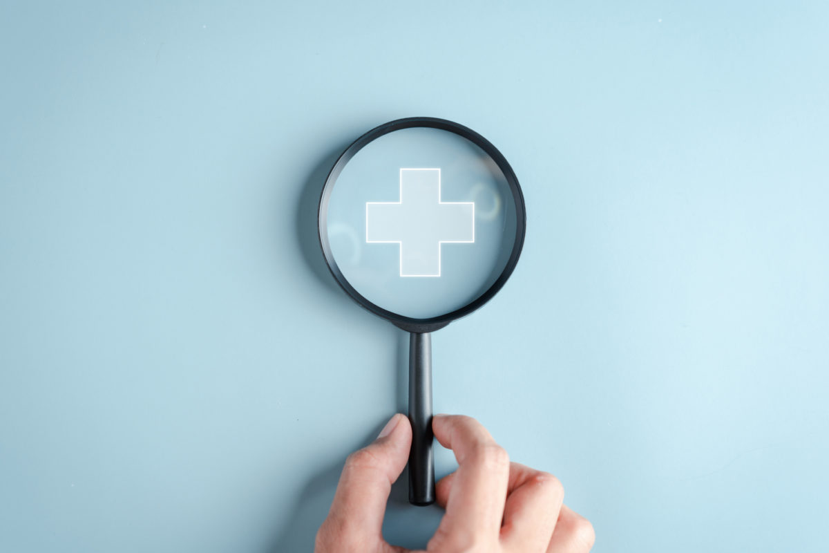 Health insurance concept. Hand people holding Magnifier focus to plus symbol and healthcare medical icon, health and access to welfare health concept.