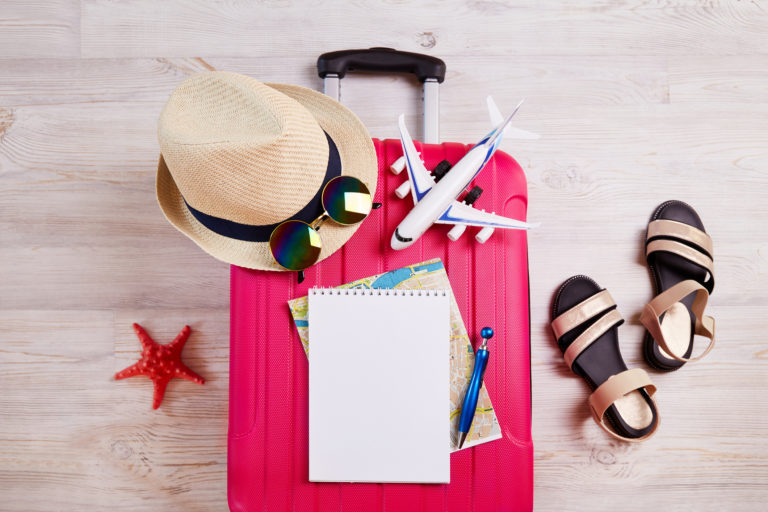 A suitcase with things and accessories for a vacation. Summer travel, preparation for the trip, packing of luggage.