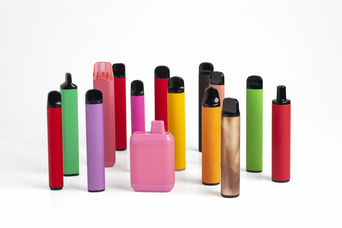 Set of colorful disposable electronic cigarettes of different shapes on a white background. The concept of modern smoking.