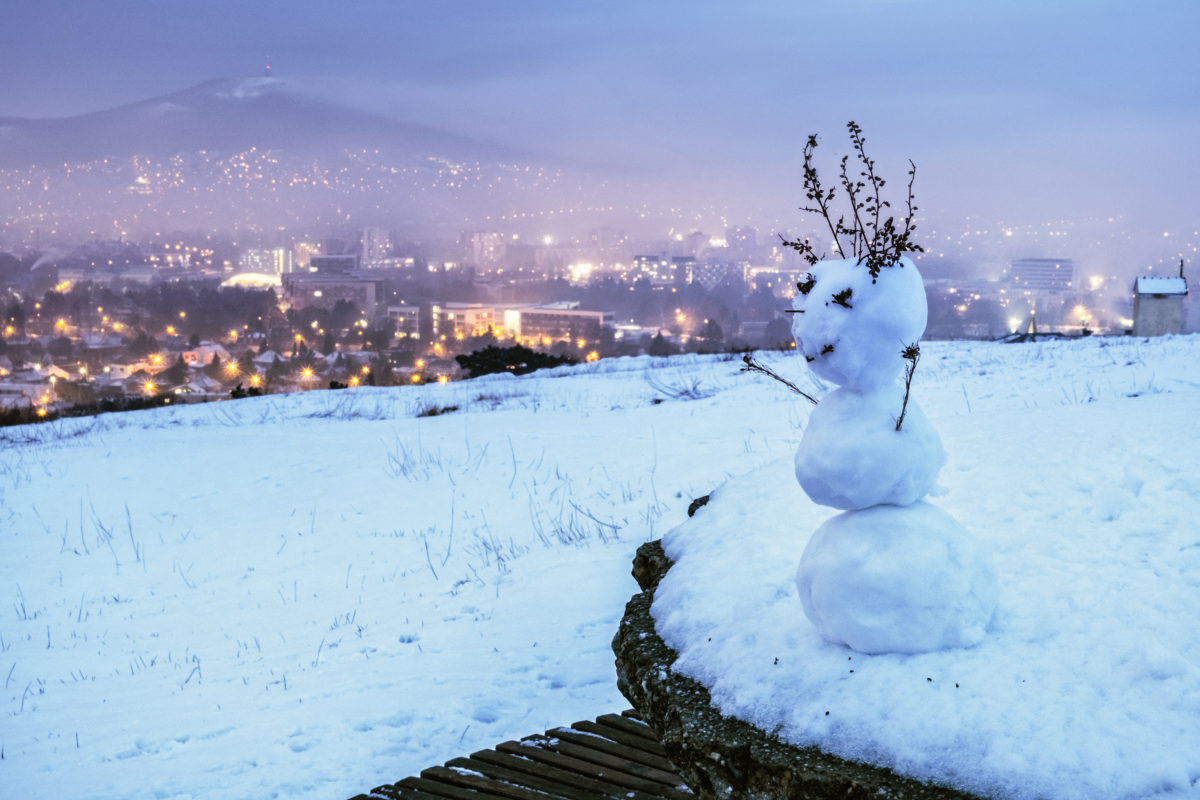 Snowman and Nitra city, Slovakia, evening photo