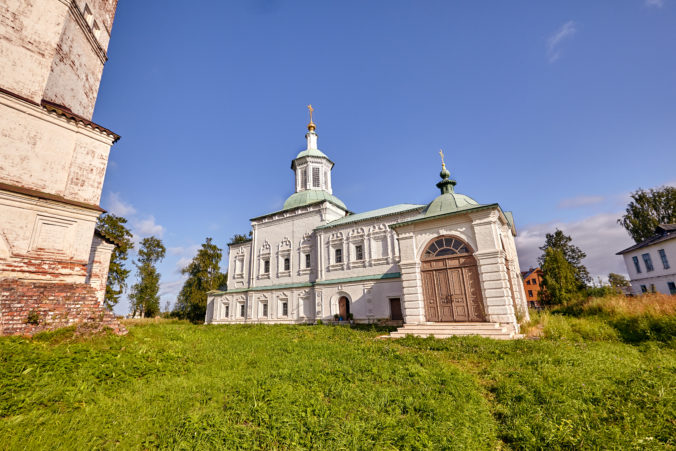 Old orthodox church at village. Summer view with floral meadow.