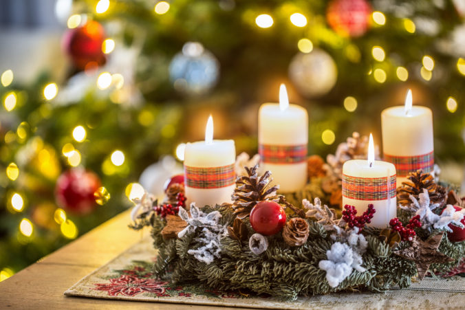 Advent wreath with four white burning candles christmas ball and decorations on a wooden background with festive atmosphere