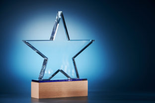 Crystal star shape trophy against blue background