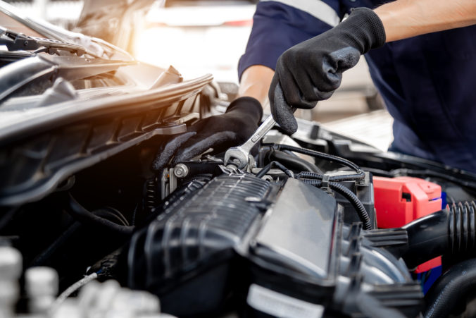 Car care maintenance and servicing, Close up hand technician auto mechanic using the wrench to repairing change spare part car engine problem and insurance service support.