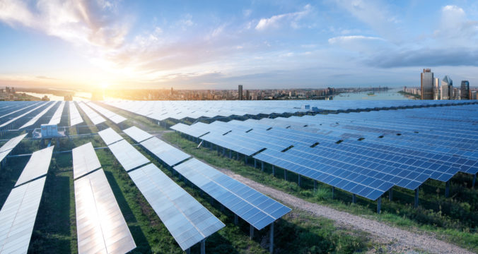Eco environmentally friendly green energy of sustainable development of solar power plant with Shanghai skyline