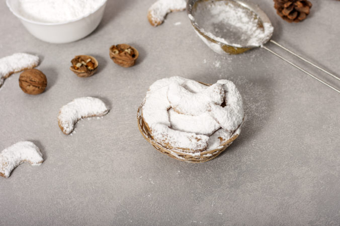 Traditional Austrian and German crescent shaped Christmas pastries - Vanillekipferl - on a gray table
