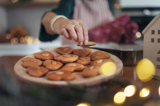 Close up of senior woman baking Christmas gingerbreads.