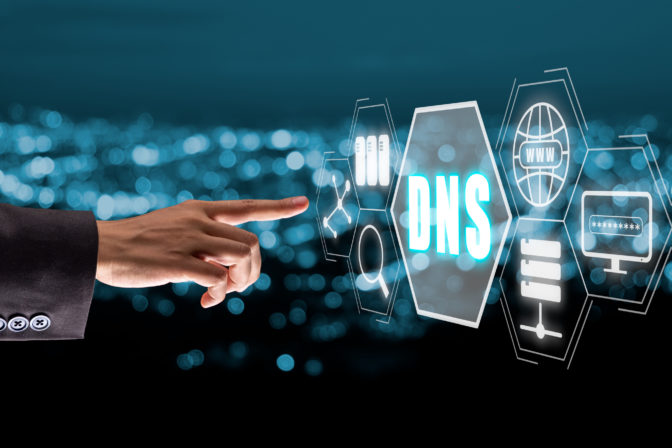 DNS, Domain name System server concept, Person hand touching domain name system server icon on virtual screen with blue bokeh background, Mixed media.