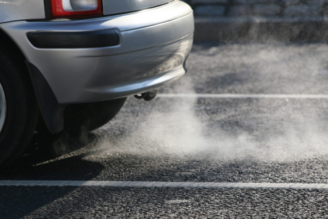 Car exhaust fumes coming from automobile polluting city air