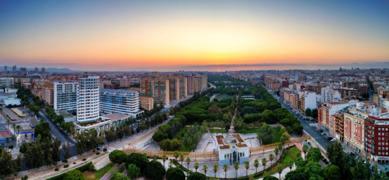 Aerial drone view of sunrise over Turia Gardens, a riverbed turned into a park, in Valencia, Spain