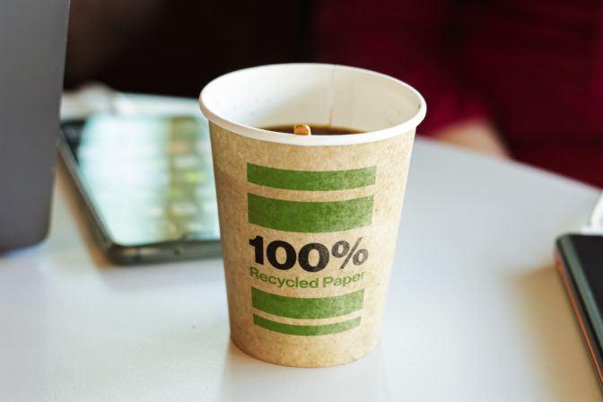 A recycled paper container containing hot coffee for a break.